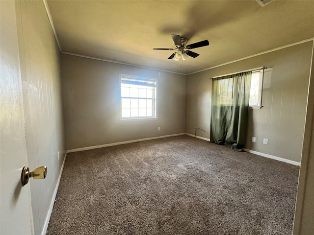 spare room featuring crown molding, ceiling fan, baseboards, and carpet floors