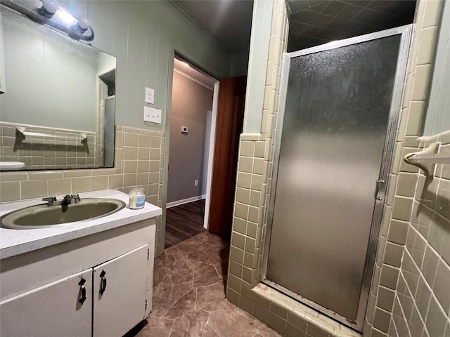 bathroom featuring a shower stall, tasteful backsplash, and vanity