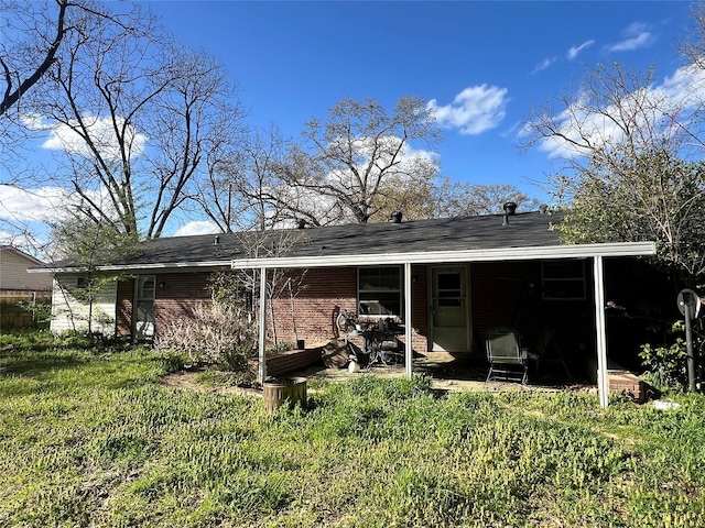 back of property featuring brick siding