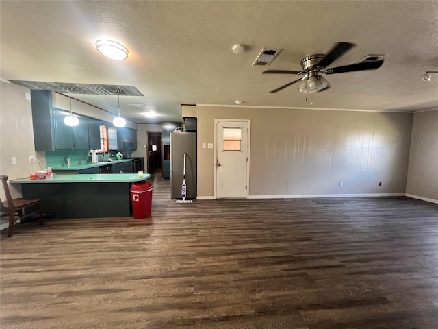 kitchen with open floor plan, visible vents, a peninsula, and dark wood finished floors