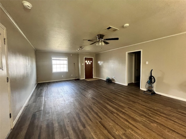 unfurnished living room featuring ornamental molding, ceiling fan, dark wood-style floors, and visible vents