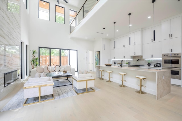 4218 Bonham St, Dallas, TX 75229 - living room with a high ceiling, light wood finished floors, plenty of natural light, and recessed lighting