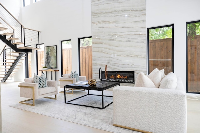4218 Bonham St, Dallas, TX 75229 - living room featuring healthy amount of natural light, a towering ceiling, stairs, and a fireplace