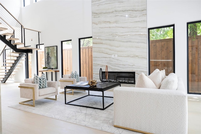 4218 Bonham St, Dallas, TX 75229 - living area featuring plenty of natural light, a high ceiling, stairs, and a high end fireplace