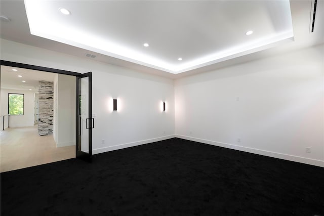 4218 Bonham St, Dallas, TX 75229 - unfurnished room featuring a raised ceiling, recessed lighting, baseboards, and dark carpet