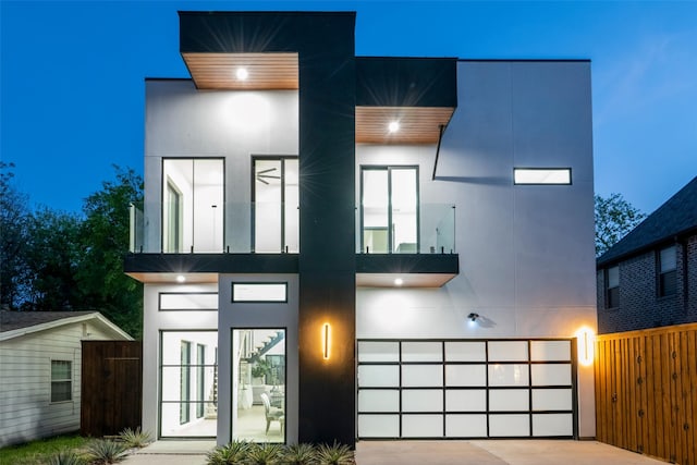 4218 Bonham St, Dallas, TX 75229 - modern home featuring stucco siding, fence, a garage, concrete driveway, and a balcony