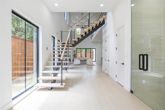 4218 Bonham St, Dallas, TX 75229 - stairway with healthy amount of natural light, a high ceiling, recessed lighting, and wood finished floors