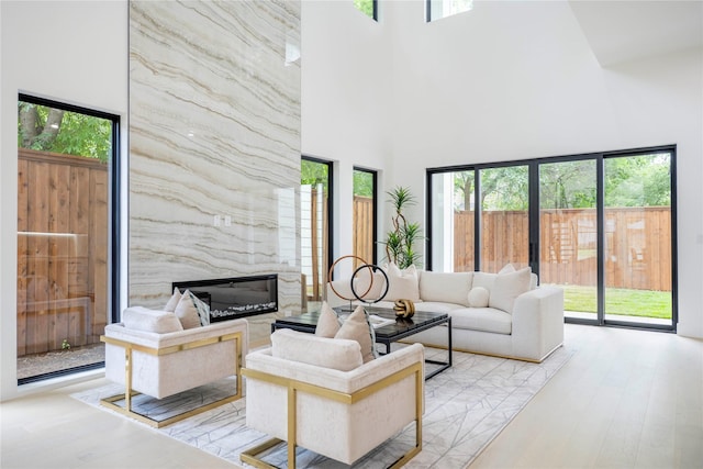 4218 Bonham St, Dallas, TX 75229 - living area with a towering ceiling, light wood-style floors, and a fireplace