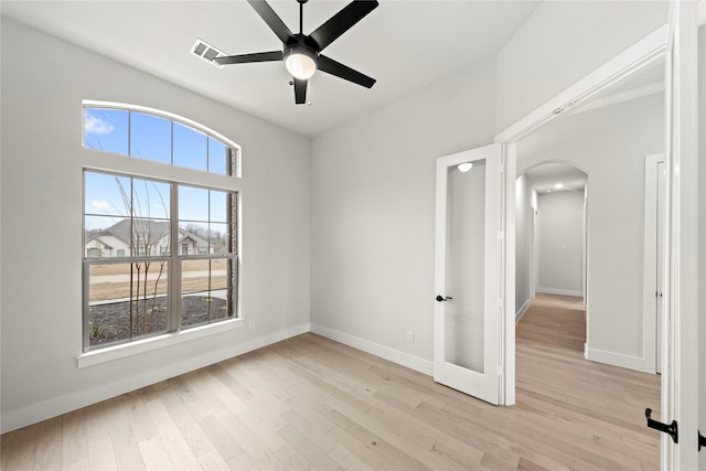 160 Waterview Dr, Gunter, TX 75058 - empty room featuring ceiling fan, visible vents, arched walkways, baseboards, and light wood finished floors