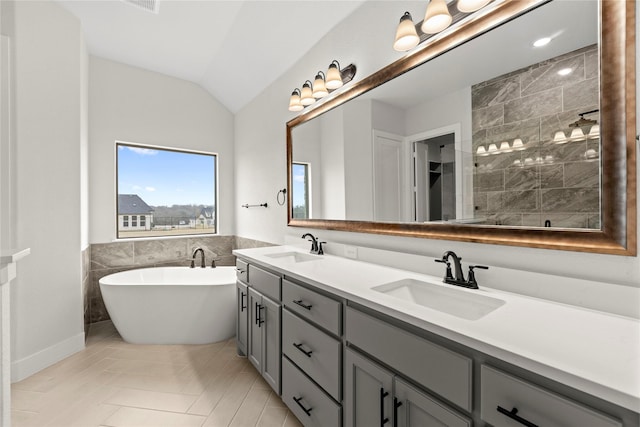160 Waterview Dr, Gunter, TX 75058 - bathroom with double vanity, a sink, lofted ceiling, and tile walls