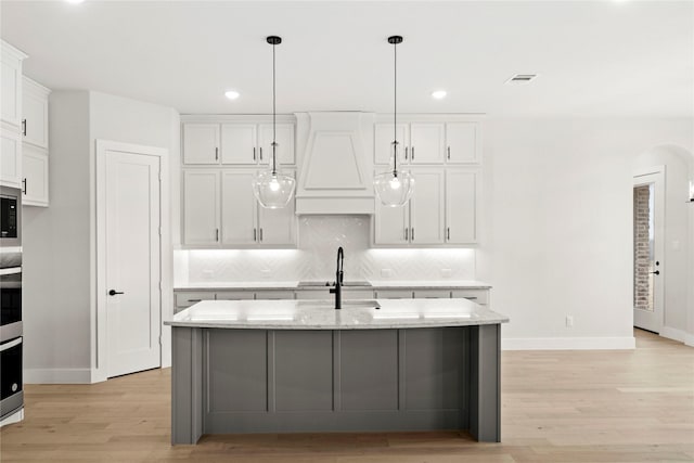 160 Waterview Dr, Gunter, TX 75058 - kitchen with white cabinets, a sink, light wood finished floors, stainless steel appliances, and decorative backsplash