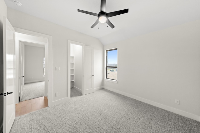 160 Waterview Dr, Gunter, TX 75058 - unfurnished bedroom featuring baseboards, a walk in closet, a ceiling fan, and light colored carpet
