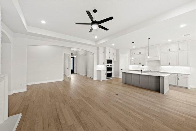 160 Waterview Dr, Gunter, TX 75058 - unfurnished living room with arched walkways, ceiling fan, recessed lighting, and light wood-type flooring