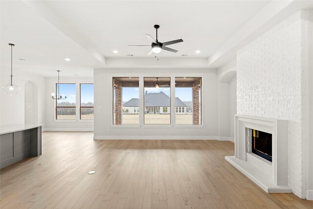160 Waterview Dr, Gunter, TX 75058 - unfurnished living room with a sink, baseboards, ceiling fan with notable chandelier, and light wood-type flooring