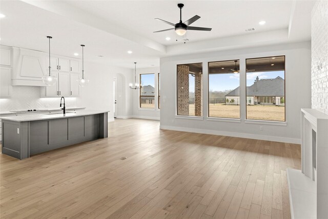 160 Waterview Dr, Gunter, TX 75058 - unfurnished living room with arched walkways, ceiling fan, recessed lighting, and light wood-type flooring