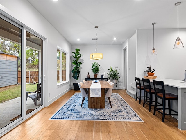 dining space with light wood-style flooring, recessed lighting, and baseboards