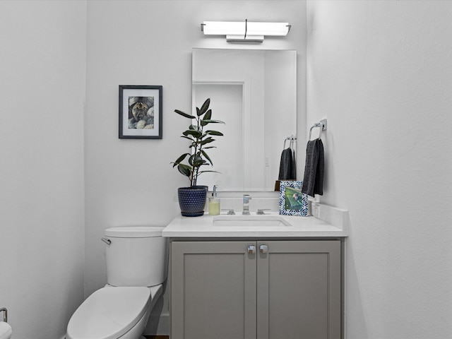 half bathroom featuring toilet and vanity