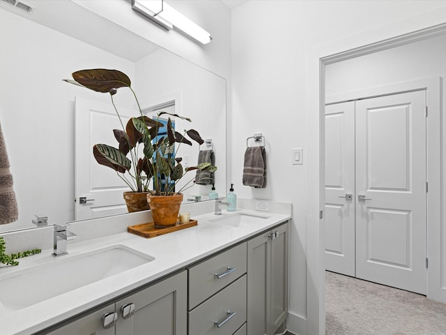 full bath with double vanity, visible vents, and a sink