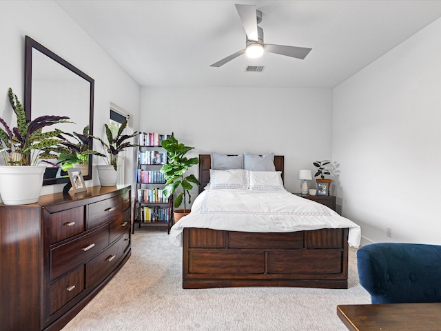 bedroom with visible vents and light colored carpet