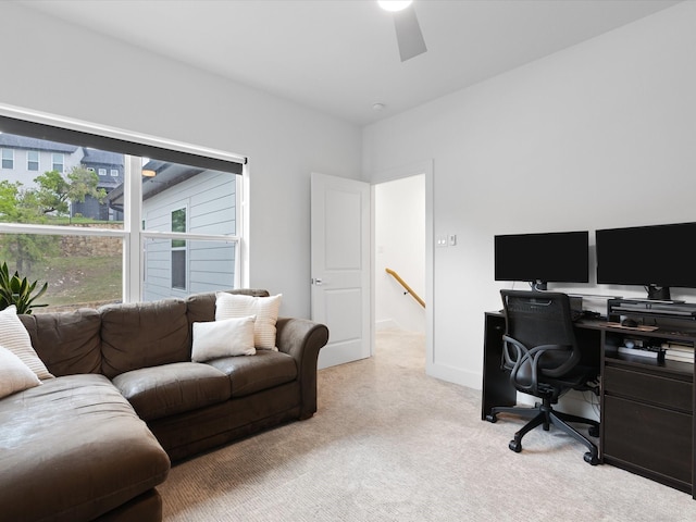 carpeted office featuring baseboards and ceiling fan