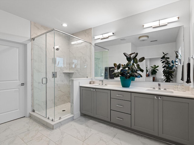 bathroom featuring a shower stall, marble finish floor, and a sink