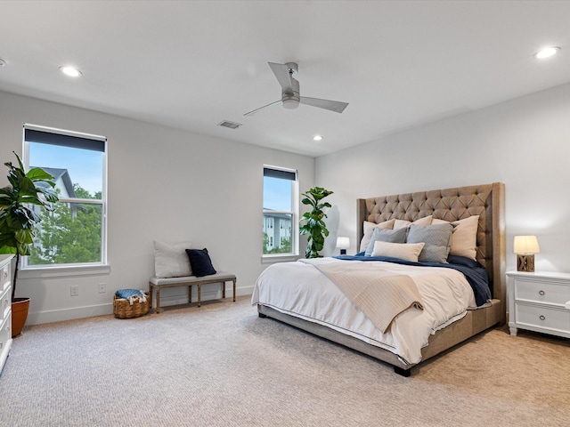 carpeted bedroom with visible vents, multiple windows, and recessed lighting