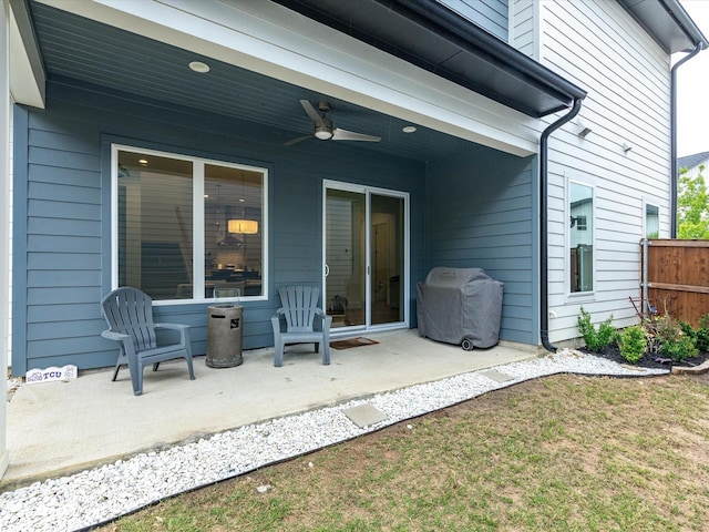 view of patio featuring fence, a grill, and a ceiling fan