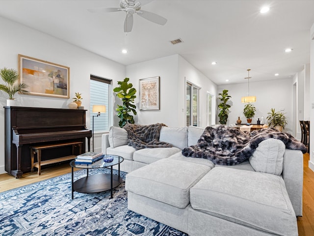 living room with recessed lighting, visible vents, a ceiling fan, and wood finished floors
