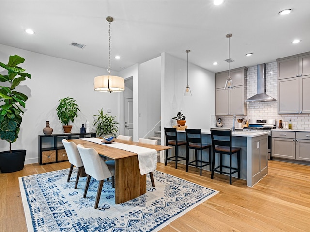 dining space with recessed lighting, stairs, visible vents, and light wood-style flooring