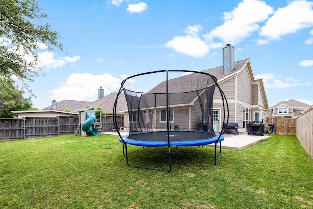 9836 Old Field Dr, Mckinney, TX 75072 - rear view of property with a trampoline, a playground, a fenced backyard, a patio area, and a lawn