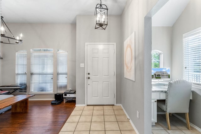 9836 Old Field Dr, Mckinney, TX 75072 - foyer featuring baseboards, a chandelier, and light wood finished floors