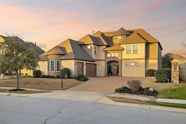 view of front of home with an attached garage, a shingled roof, driveway, and stucco siding
