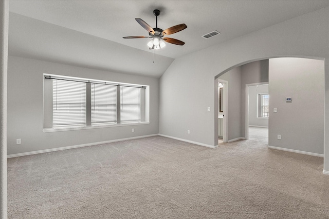 5010 Huffines Blvd, Royse City, TX 75189 - unfurnished room featuring lofted ceiling, visible vents, arched walkways, light colored carpet, and ceiling fan