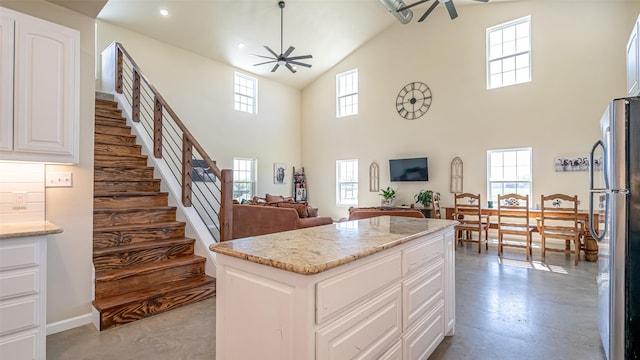 kitchen with a sink, appliances with stainless steel finishes, white cabinets, and backsplash