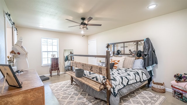 bedroom featuring baseboards, ceiling fan, recessed lighting, and a barn door