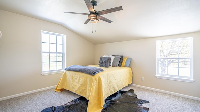 carpeted bedroom featuring baseboards, vaulted ceiling, and ceiling fan