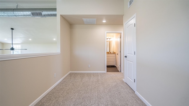 hall with recessed lighting, baseboards, visible vents, and carpet