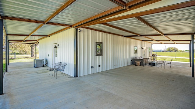 view of patio featuring central AC and a carport