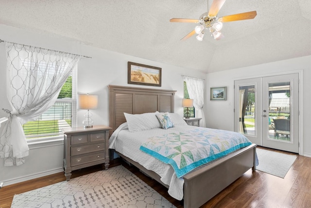 bedroom featuring vaulted ceiling, french doors, a textured ceiling, access to outside, and multiple windows