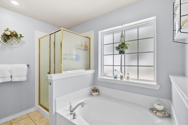 full bathroom featuring a garden tub, tile patterned flooring, and a stall shower