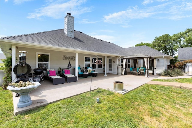 rear view of property with a lawn, a gazebo, an outdoor living space, and a patio
