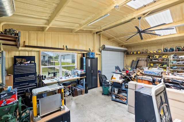 garage with a workshop area and a ceiling fan