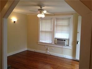 unfurnished room featuring cooling unit, wood finished floors, baseboards, and ceiling fan