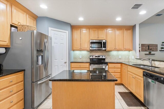 2905 Pueblo Dr, Waco, TX 76712 - kitchen featuring appliances with stainless steel finishes, a sink, light tile patterned floors, light brown cabinets, and recessed lighting