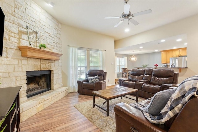 2905 Pueblo Dr, Waco, TX 76712 - living room featuring a stone fireplace, light wood-style flooring, a ceiling fan, and recessed lighting