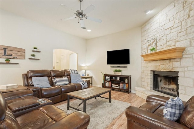 2905 Pueblo Dr, Waco, TX 76712 - living room with arched walkways, ceiling fan, wood finished floors, a fireplace, and baseboards