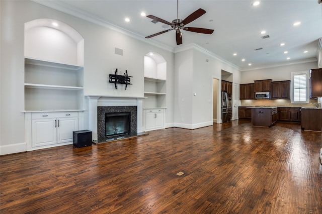 2110 Helsminster Dr, Dallas, TX 75201 - unfurnished living room featuring a ceiling fan, a fireplace, built in shelves, dark wood-type flooring, and recessed lighting