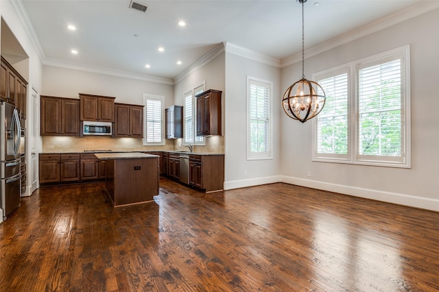 2110 Helsminster Dr, Dallas, TX 75201 - kitchen featuring appliances with stainless steel finishes, a kitchen island, dark wood-type flooring, a chandelier, and tasteful backsplash