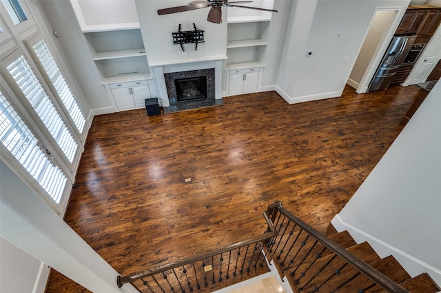 2110 Helsminster Dr, Dallas, TX 75201 - unfurnished living room with a ceiling fan, baseboards, a premium fireplace, and built in shelves