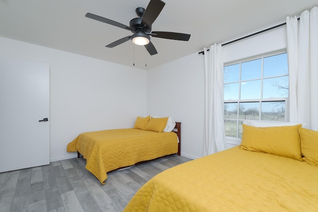 909 Crockett St, Santa Anna, TX 76878 - bedroom featuring wood finished floors, baseboards, and a ceiling fan